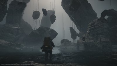 Death Stranding 2: On the Beach screenshot showing Sam walking through a strange environment of floating rocks