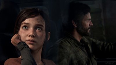 The Last of Us Part I screenshot showing Ellie starting out of a car window while Joel drives
